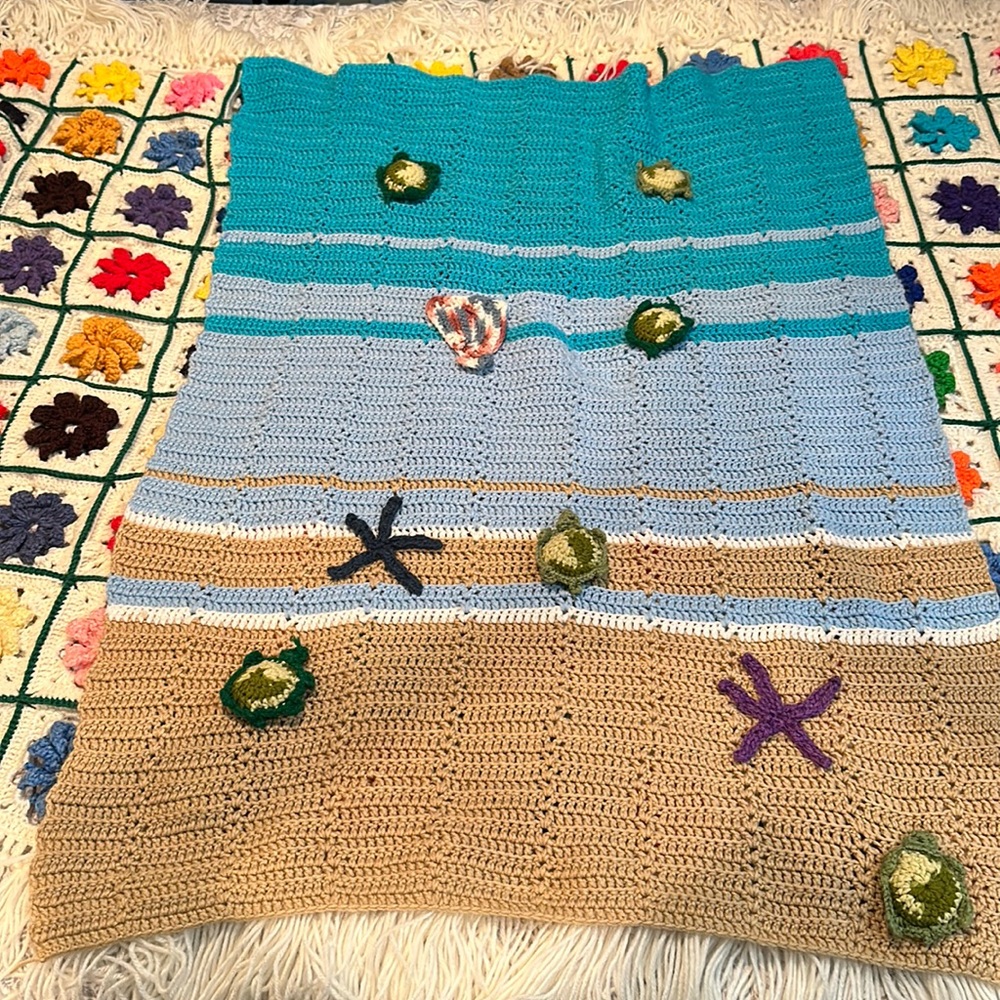 Crochet baby sea turtle at beach crib blanket